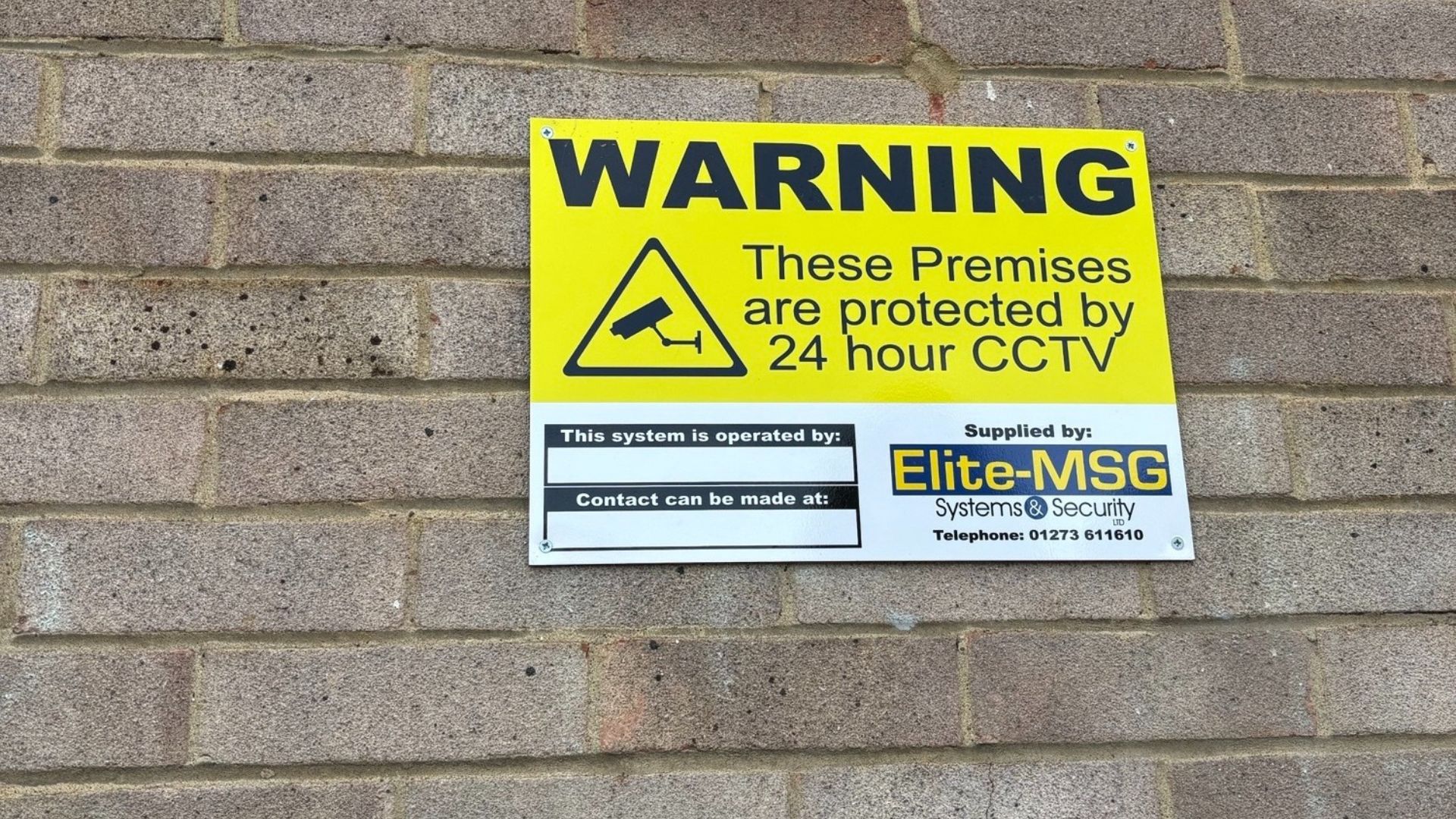 Image of new CCTV sign on a brick wall